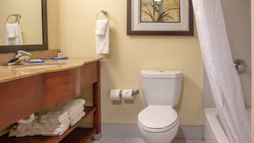 A bathroom with a toilet, sink, and a shower curtain.