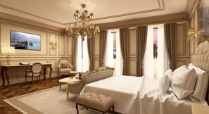 A luxurious hotel room with a large bed, a desk, a chair, and a television displaying a scenic view. - Hotel Savoia e Jolanda, WorldHotels Elite (Venice)