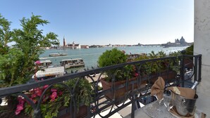 A balcony with potted plants, a metal bucket, and a glass. - Hotel Savoia e Jolanda, WorldHotels Elite (Venice)