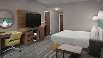 Una habitación de hotel con cama, escritorio, silla, televisión, espejo y lámpara.