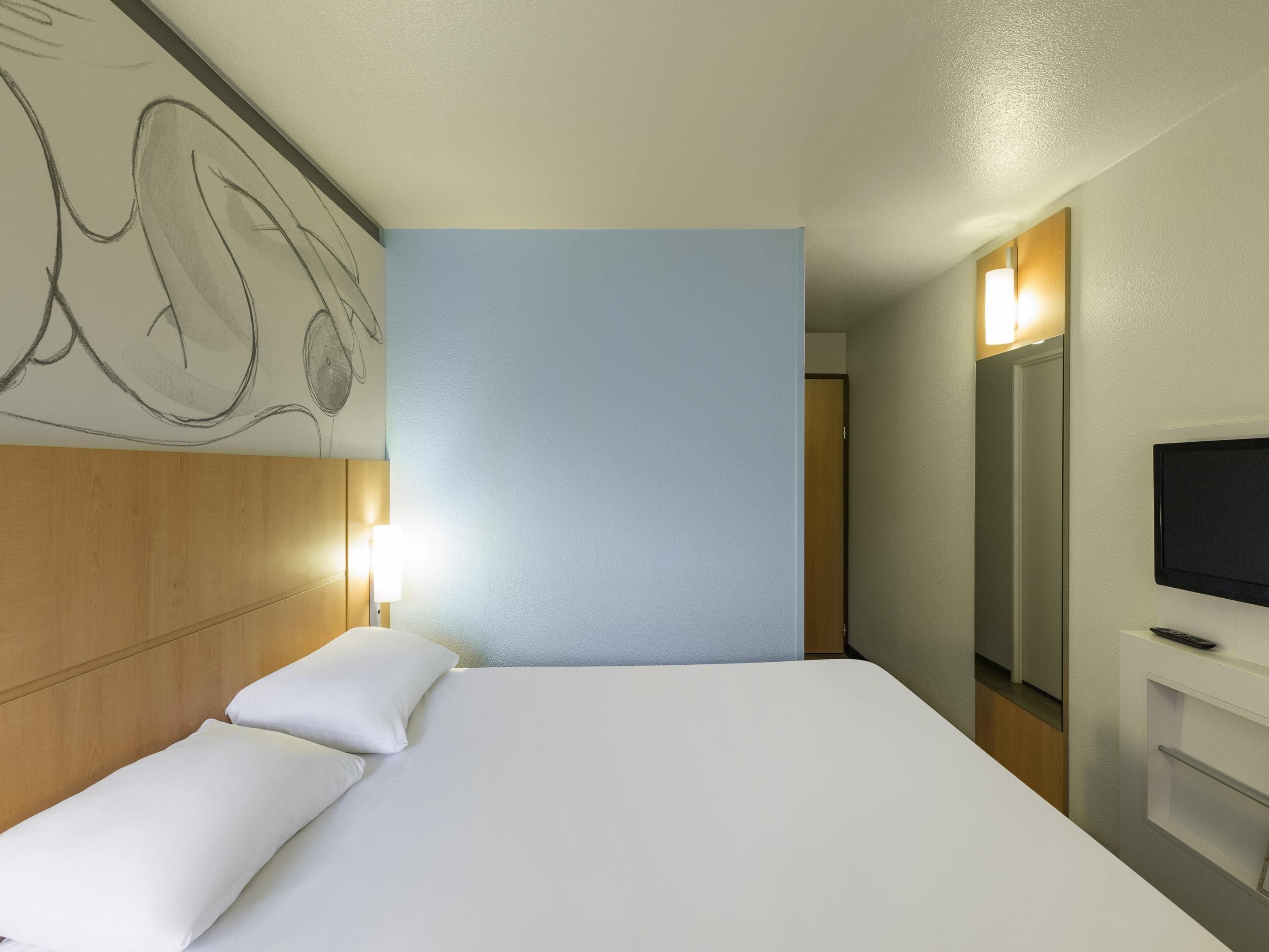 Premium bedding, desk, laptop workspace, blackout drapes