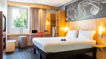 Premium bedding, desk, laptop workspace, blackout drapes