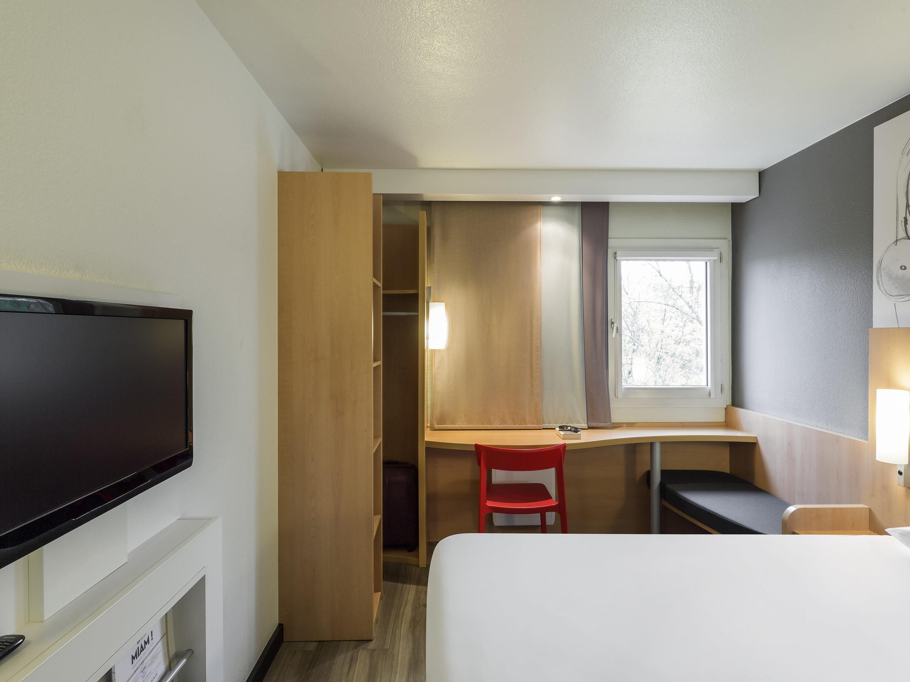 Premium bedding, desk, laptop workspace, blackout drapes