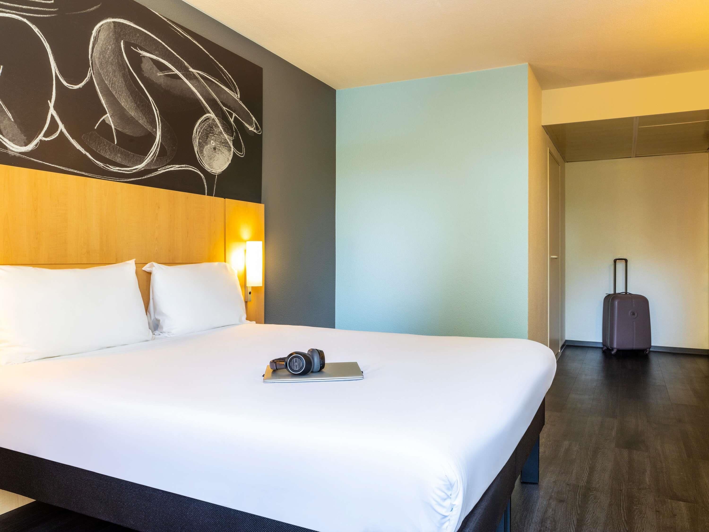 Premium bedding, desk, laptop workspace, blackout drapes