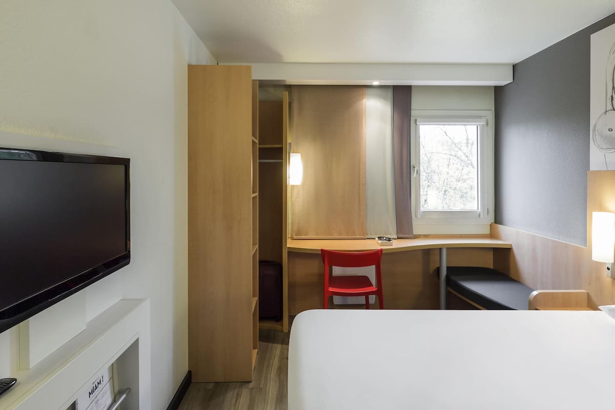 Premium bedding, desk, laptop workspace, blackout curtains
