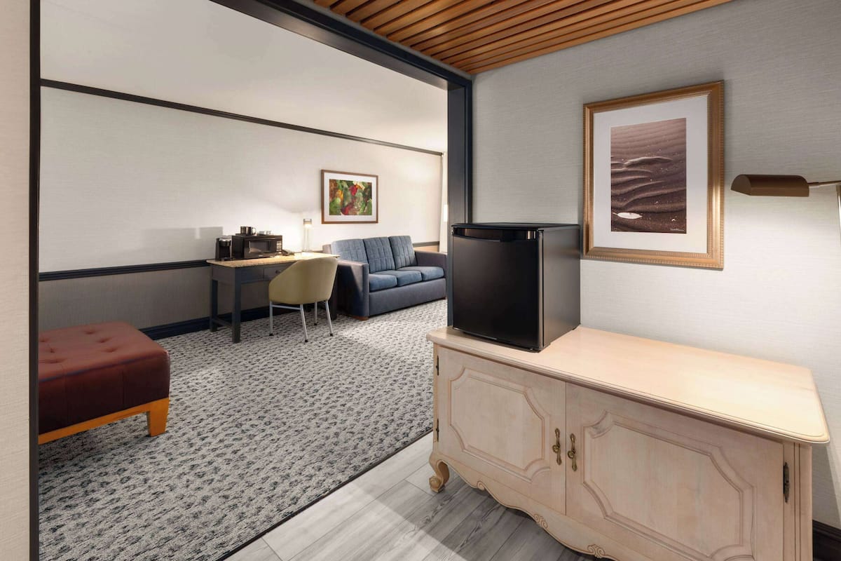 A modern living room with a sofa, a coffee table, a TV, and a cabinet.