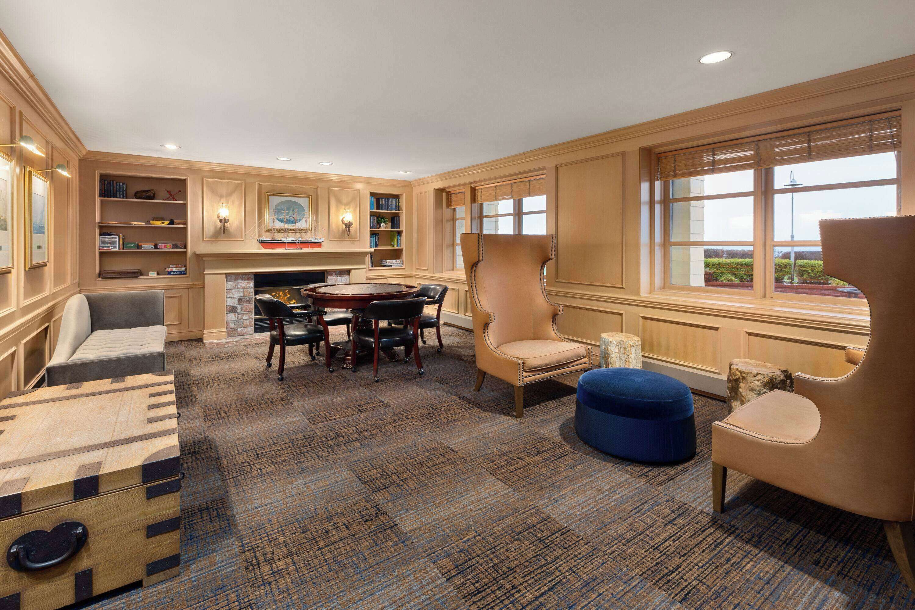 A spacious room with a fireplace, a dining table, and comfortable seating.