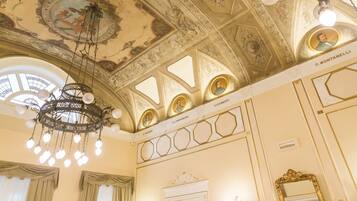 An ornate ceiling with intricate designs and a chandelier.