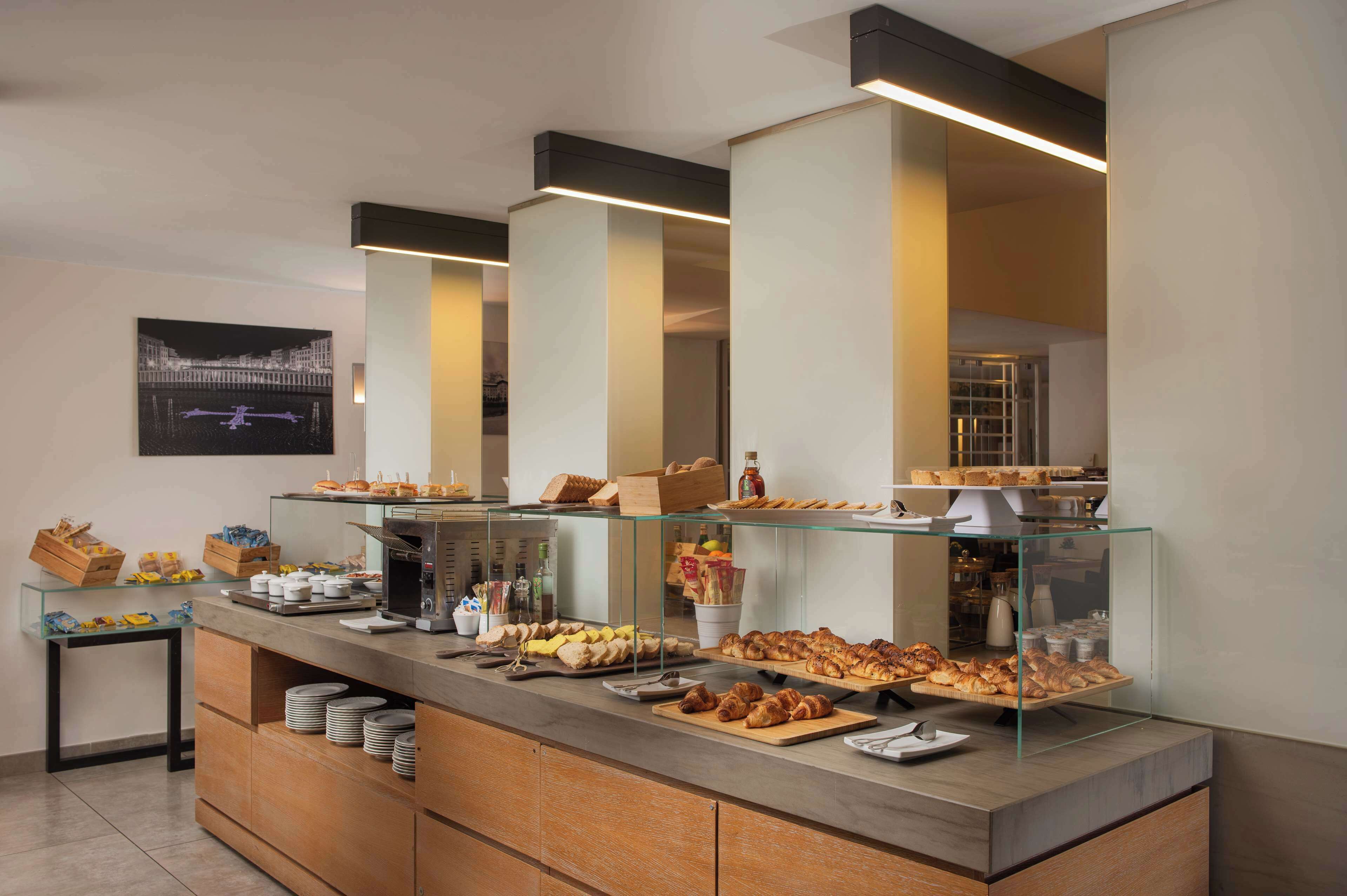 A buffet area with various food items displayed on glass counters and shelves.