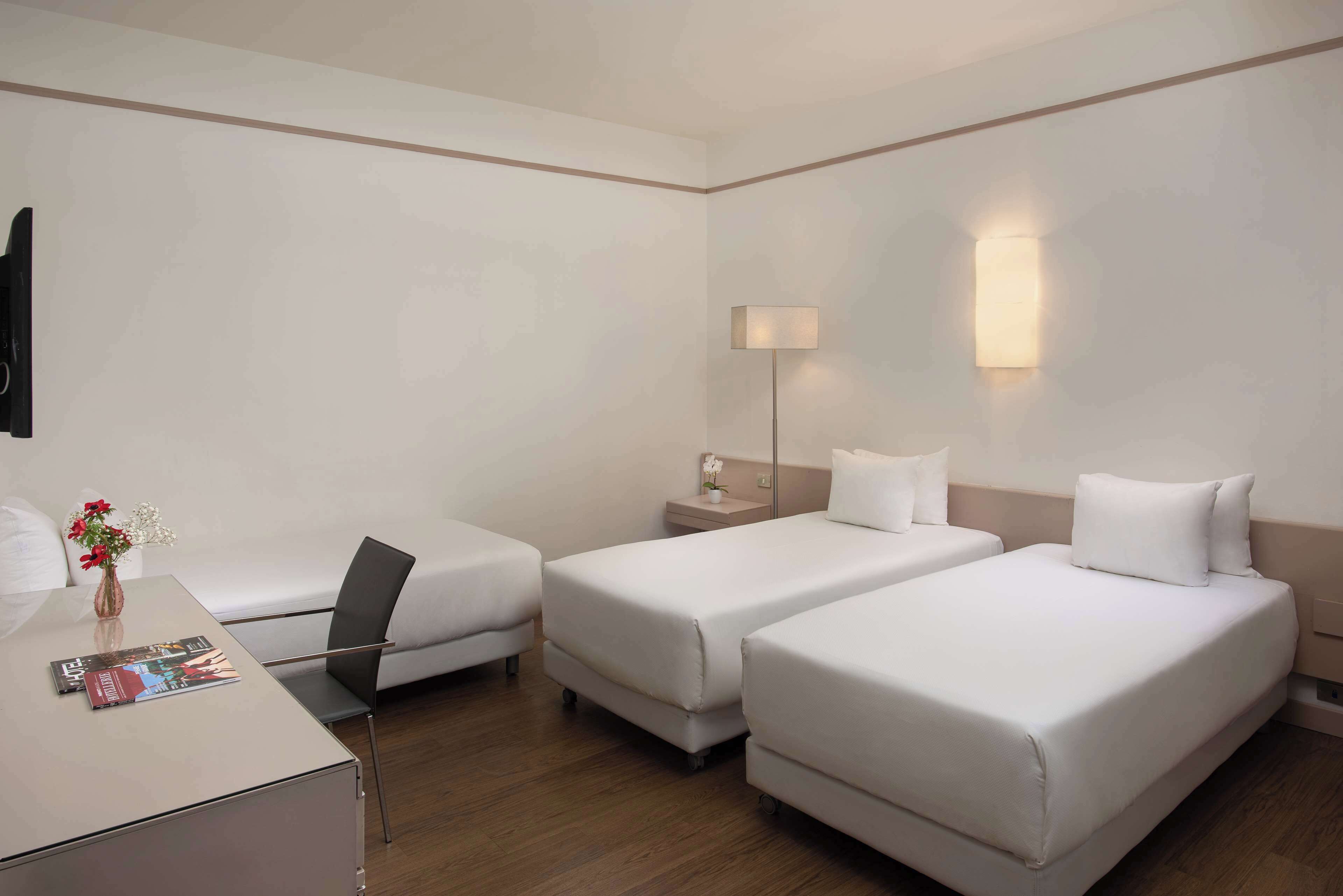 Standaard driepersoonskamer | Een minibar, een kluis op de kamer, een bureau, een laptopwerkplek