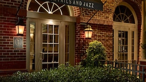 A brick building with a sign reading "Piccolo Cocktails and Jazz". - The Hotel At Auburn University (Auburn)