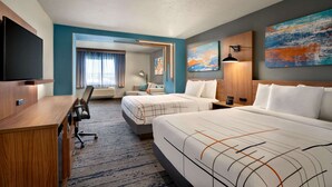 A hotel room with two beds, a desk, a chair, a TV, and artwork on the walls. - La Quinta Inn & Suites by Wyndham Springfield (Springfield)
