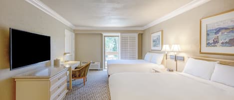 A hotel room with two beds, a desk with a flat-screen TV, a chair, and a window with blinds.