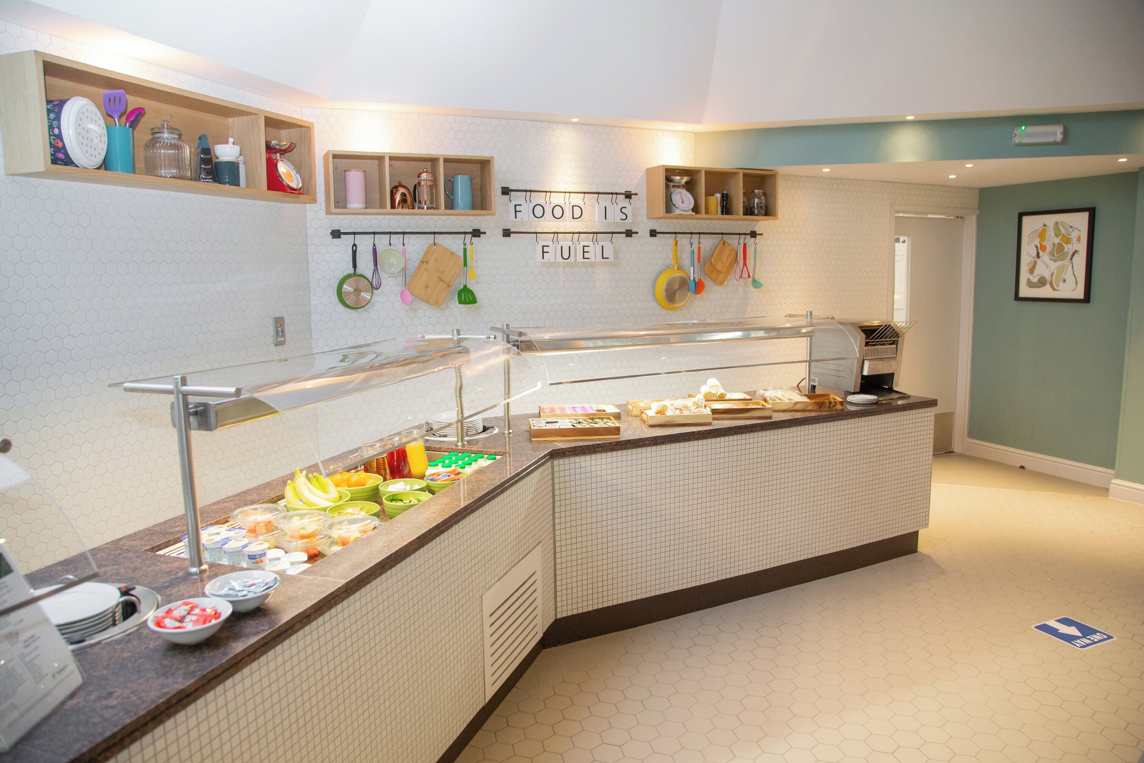 A breakfast buffet with various food items and utensils.