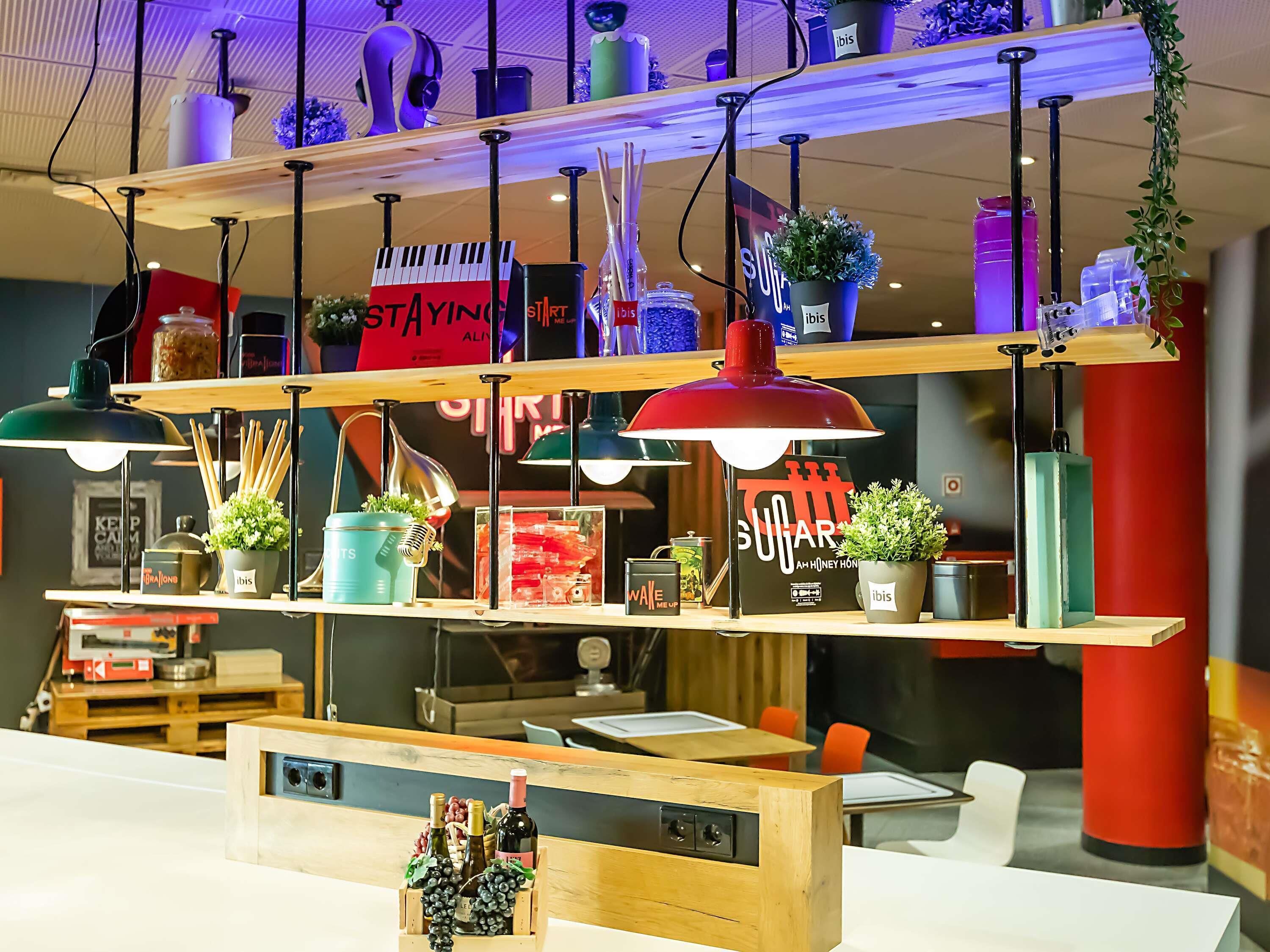 A multi-tiered shelf with various items including potted plants, a wine rack, and decorative objects.