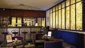 A restaurant with a bar area, high-backed chairs, and a large window with handwritten notes.