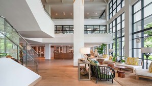 A spacious interior with a high ceiling, large windows, and a central chandelier. - Baker's Cay Resort Key Largo, Curio Collection by Hilton (Key Largo)