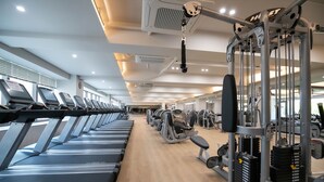 A gym with treadmills, weight machines, and a variety of exercise equipment. - Koreana Hotel (Seoul)