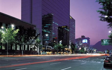 A modern hotel building with a prominent sign reading "KOREANA HOTEL".