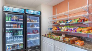 Two refrigerated beverage dispensers labeled 'CHILLED' and 'FROZEN' with various drinks inside.