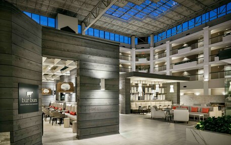 A spacious indoor area with a high ceiling, multiple levels, and a skylight.
