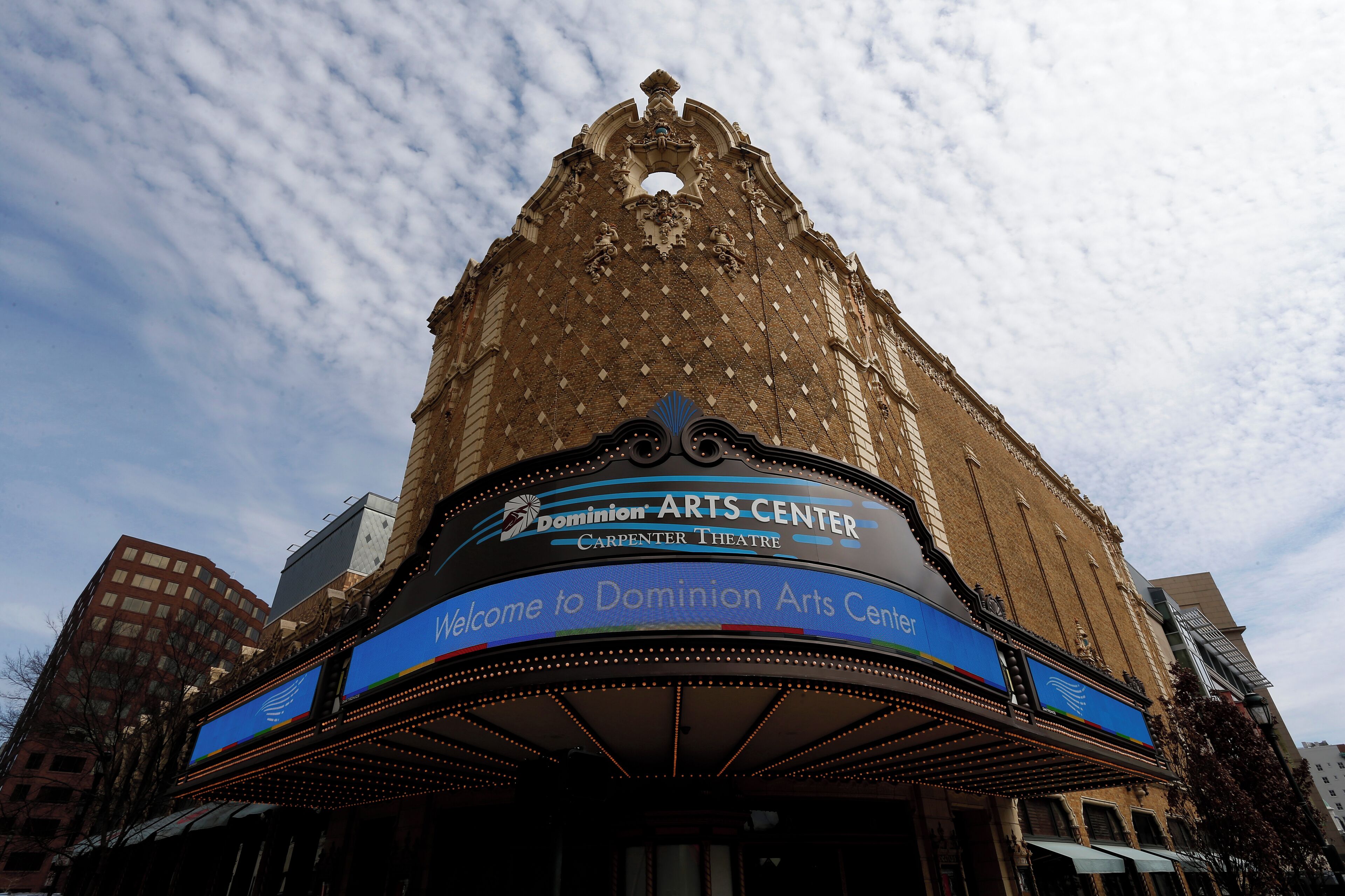 The exterior of the Dominion Arts Center with a prominent marquee and a classic architectural design.