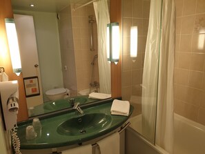 Bathtub, eco-friendly toiletries, hair dryer, towels