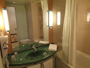 Bathtub, eco-friendly toiletries, hair dryer, towels