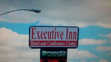 A sign for the Executive Inn Hotel and Conference Center.