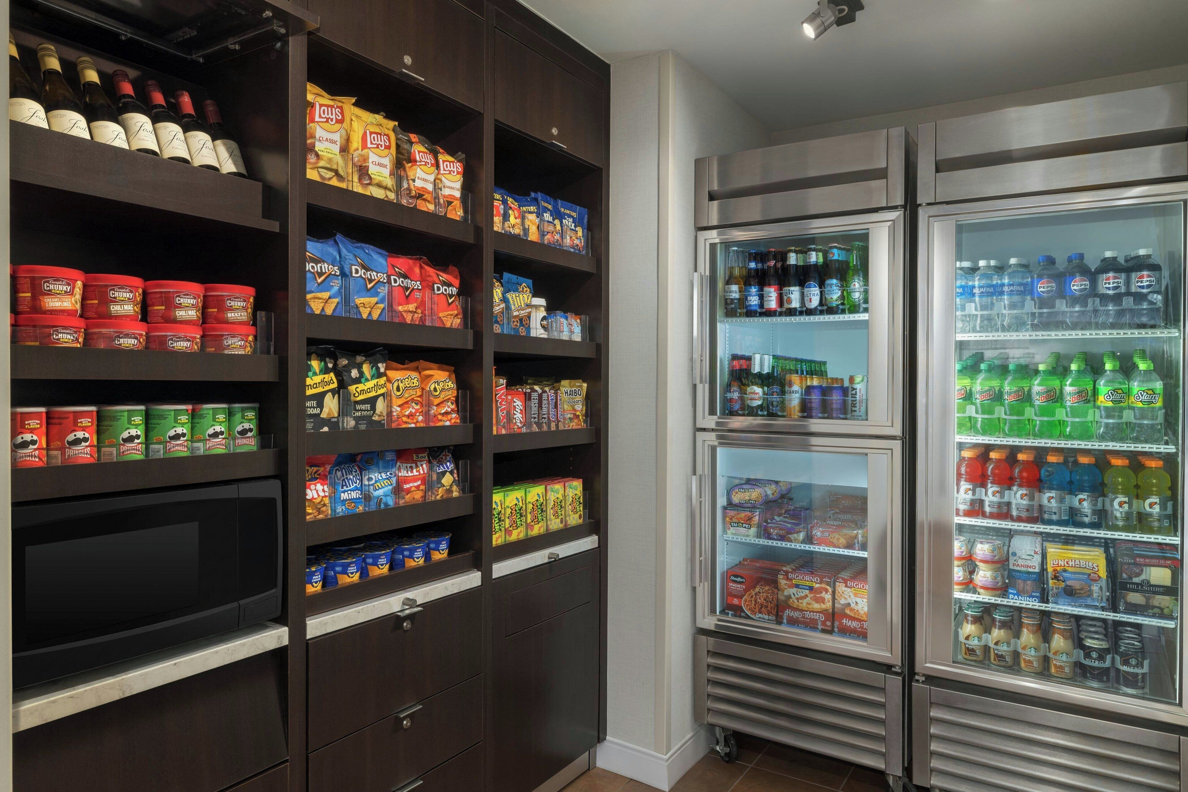 A snack and beverage refrigerator stocked with various items.