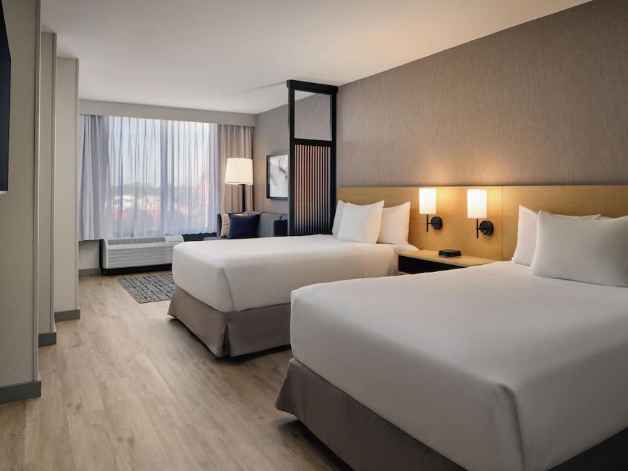 Premium bedding, desk, laptop workspace, blackout drapes