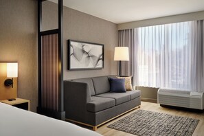 Premium bedding, desk, laptop workspace, blackout drapes