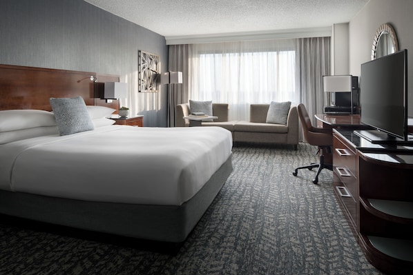 A hotel room with a large bed, a desk, a chair, and a television. - Bakersfield Marriott at the Convention Center (Bakersfield)