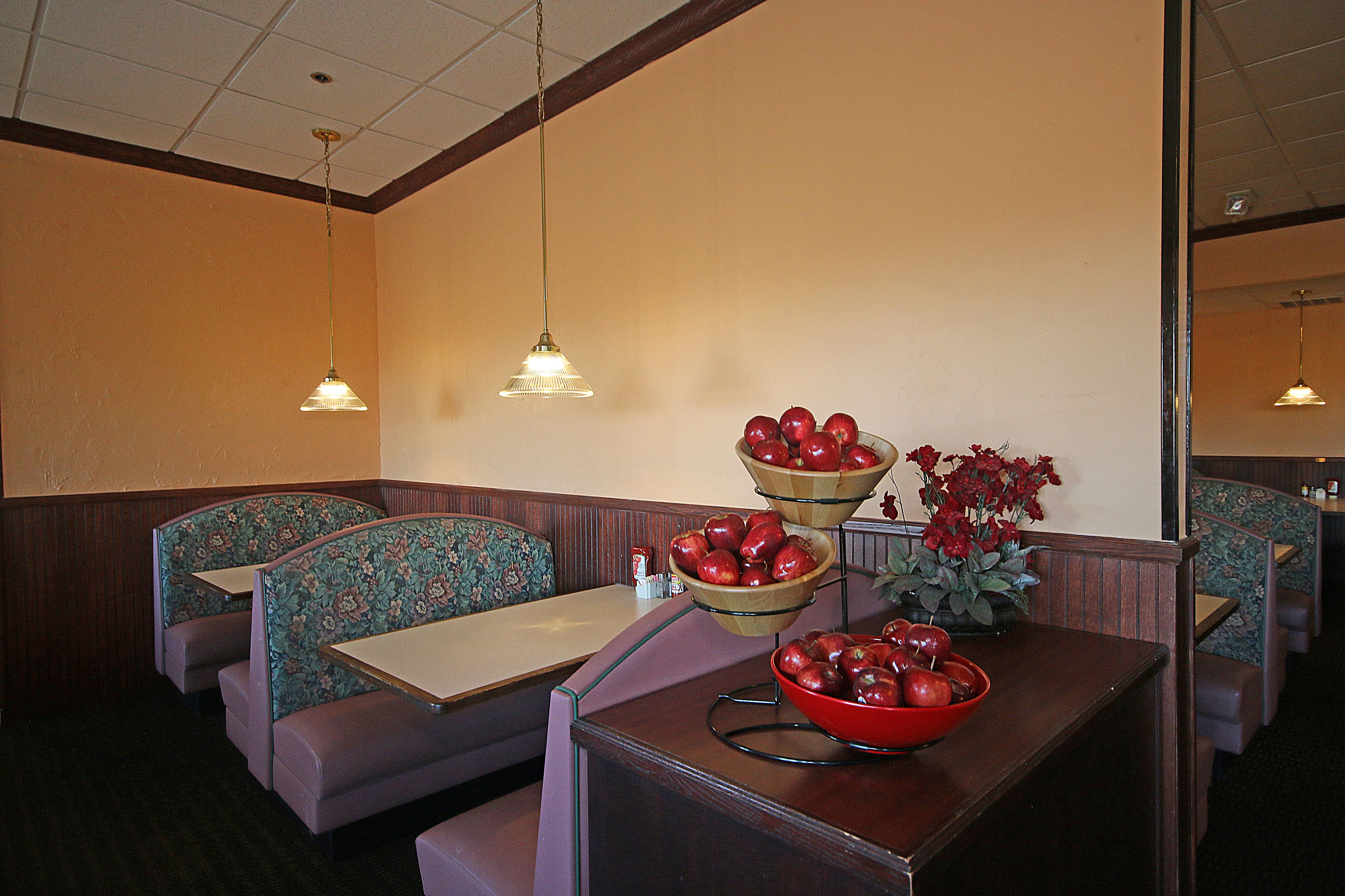 A restaurant interior with booths, tables, and a decorative centerpiece.