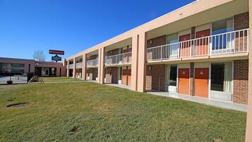 A multi-story motel with a flat roof, brick exterior, and a sign indicating it is a Ramada motel.