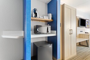 A modern hotel room with a microwave, refrigerator, coffee maker, and a TV on a stand. - Holiday Inn Express Hopewell - Fort Lee by IHG (Hopewell)