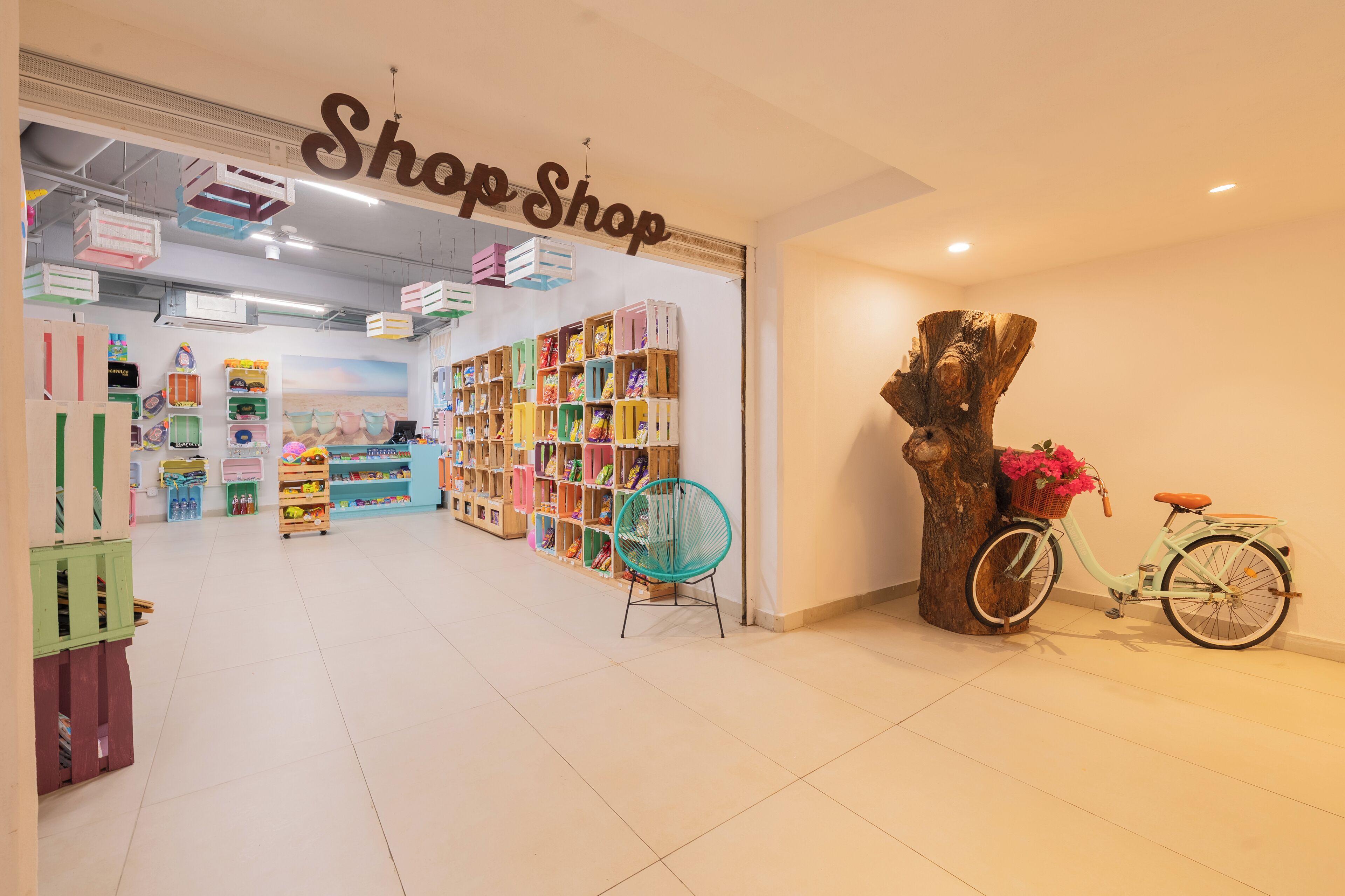 A shop with colorful storage boxes and a bicycle with a basket.