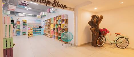 A shop with colorful storage boxes and a bicycle with a basket.