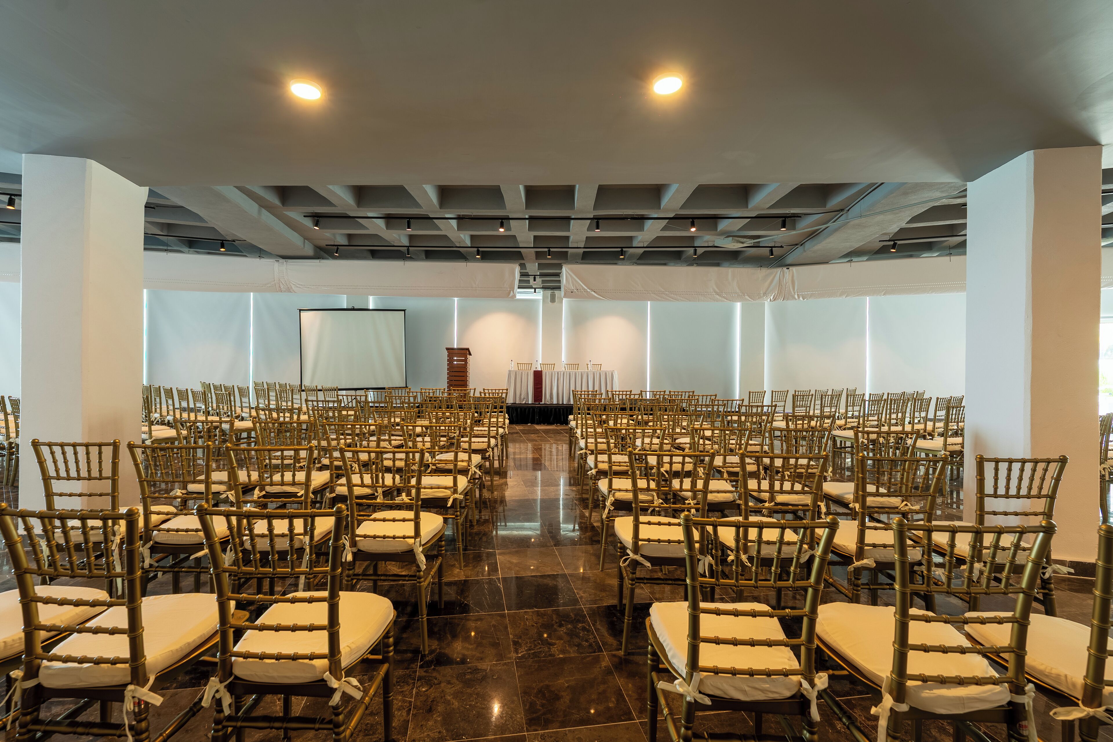 A large hall with rows of chairs arranged for an event.