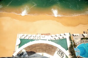 On the beach, sun-loungers, beach umbrellas, beach towels