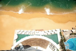 On the beach, sun-loungers, beach umbrellas, beach towels