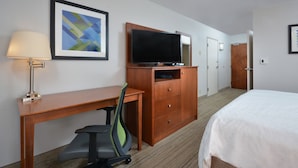 A hotel room with a wooden desk, a television, a chair, a bed, and a door. - Holiday Inn Express Lynchburg by IHG (Lynchburg)