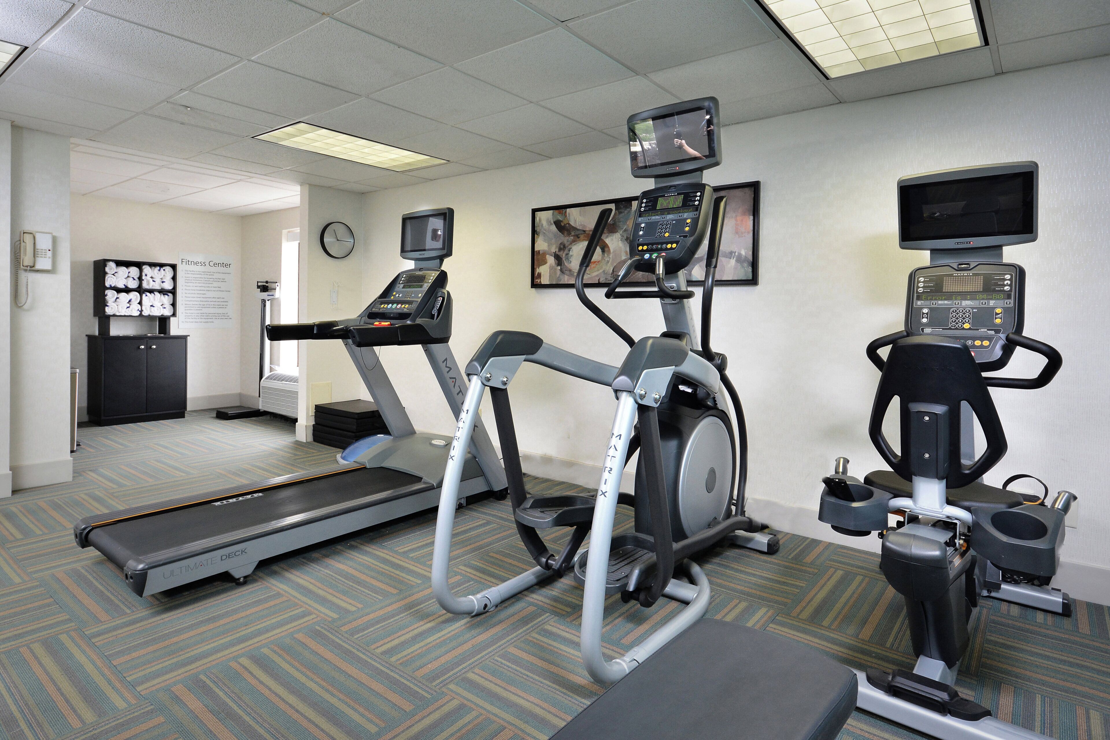 A fitness center with treadmills, an elliptical, and a stationary bike.
