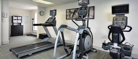 A fitness center with treadmills, an elliptical, and a stationary bike.