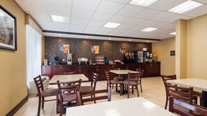 A restaurant with a counter, seating area, and various food and drink dispensers. - Best Western Springfield West Inn (West Springfield)