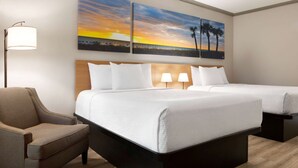 A hotel room with two beds, a chair, and two wall-mounted lamps. - Days Inn by Wyndham Kingsland Naval Base I-95 (Kingsland)