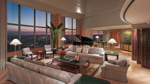 A spacious living room with a grand piano, comfortable seating, and large windows offering a city view. - Shangri-La Far Eastern, Taipei (Taipei)