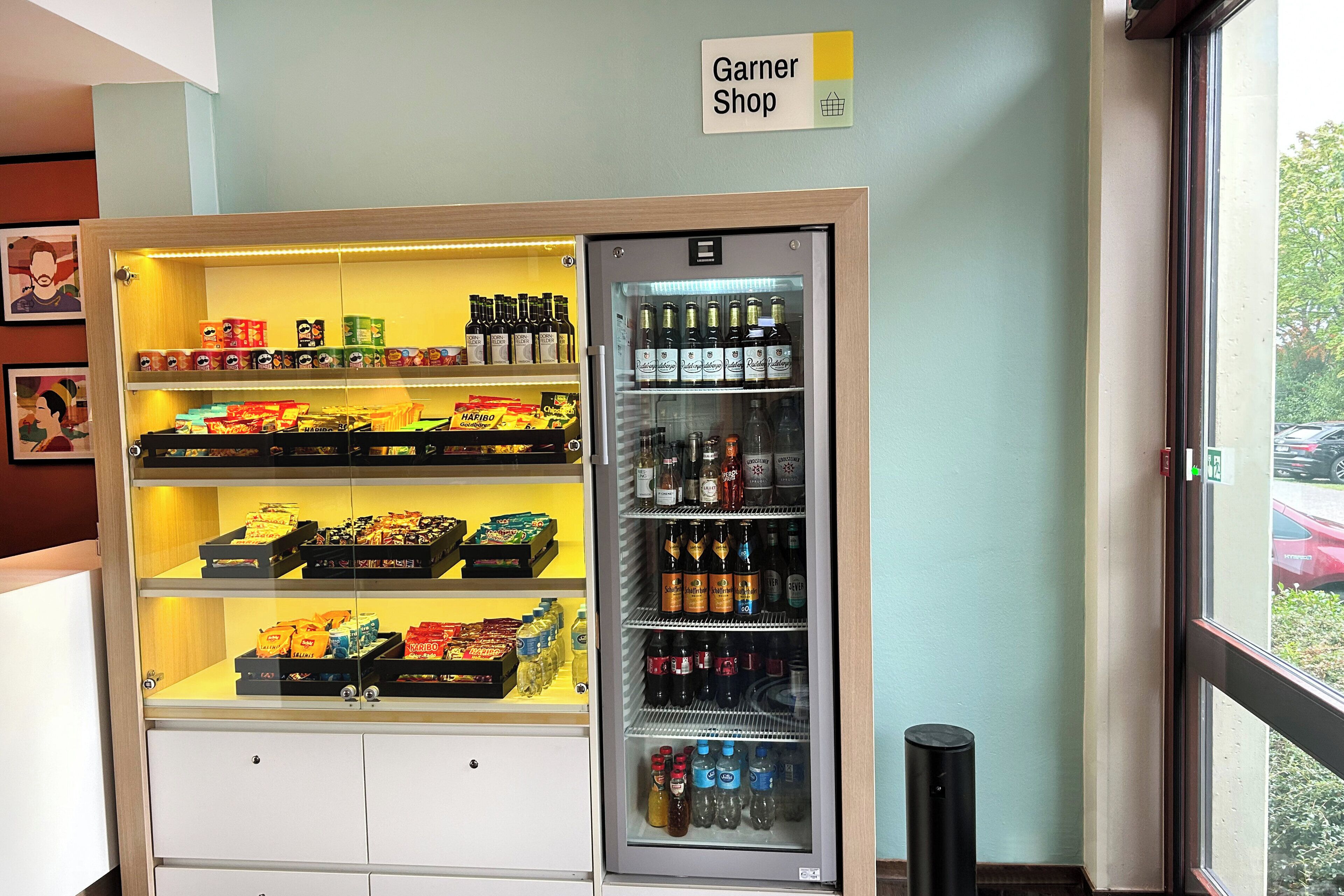 A refrigerated display case in a store with various packaged goods and beverages.