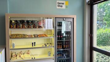 A display case with snacks and beverages, a sign for 'Garner Shop', and a refrigerated display.
