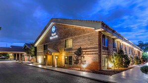 A Best Western hotel with a brick facade, large windows, and a covered entrance. - Best Western Denver Southwest (Lakewood)